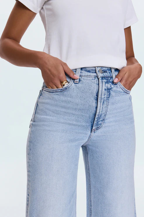 A relaxed, ultra wide leg silhouette featuring a raw finished hem and wide, stitched cuffs. Crafted from our signature comfort stretch denim to provide a structured shape with just the right give. Sun-Kissed Vintage is a light blue, blasted denim wash with a contoured, slimming fade and whisker details.