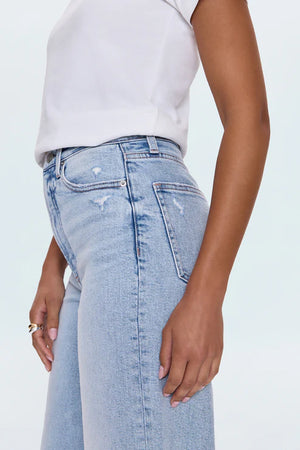 A relaxed, ultra wide leg silhouette featuring a raw finished hem and wide, stitched cuffs. Crafted from our signature comfort stretch denim to provide a structured shape with just the right give. Sun-Kissed Vintage is a light blue, blasted denim wash with a contoured, slimming fade and whisker details.