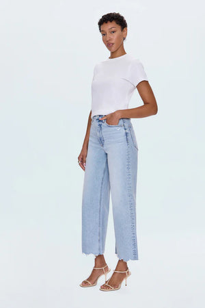 A relaxed, ultra wide leg silhouette featuring a raw finished hem and wide, stitched cuffs. Crafted from our signature comfort stretch denim to provide a structured shape with just the right give. Sun-Kissed Vintage is a light blue, blasted denim wash with a contoured, slimming fade and whisker details.