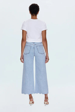 A relaxed, ultra wide leg silhouette featuring a raw finished hem and wide, stitched cuffs. Crafted from our signature comfort stretch denim to provide a structured shape with just the right give. Sun-Kissed Vintage is a light blue, blasted denim wash with a contoured, slimming fade and whisker details.