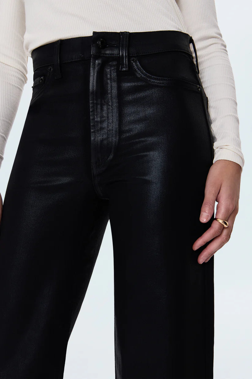 Black leather pants worn by a person on a white background
