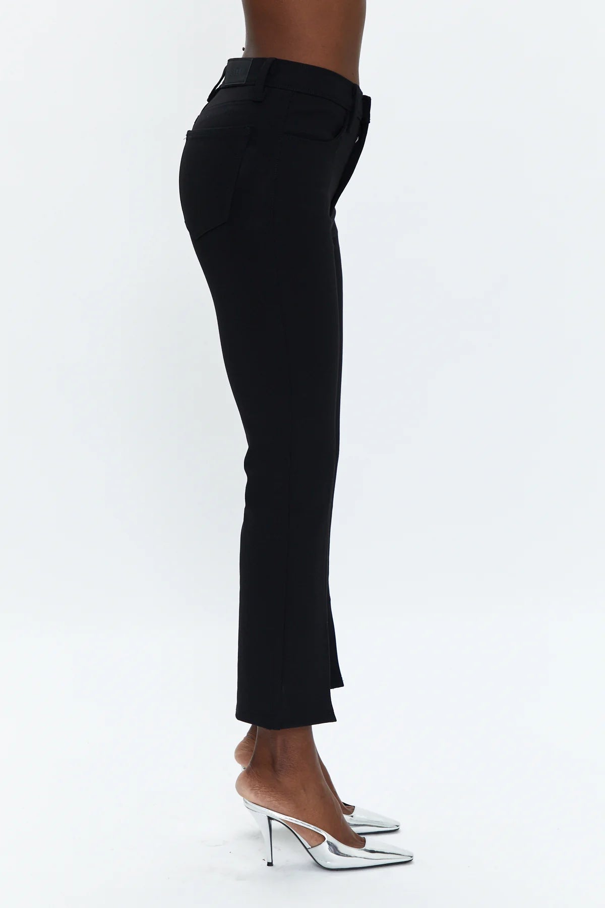 A chic pant you can everywhere, all the time. In a cropped boot cut fit, it hugs you from the hips to knee and flares out right above the calf for a proportional effect. Featured in a rich saturated black with center front slits at the hem, this pant is made in our super stretchy Ponte fabric that comfortably holds you in.