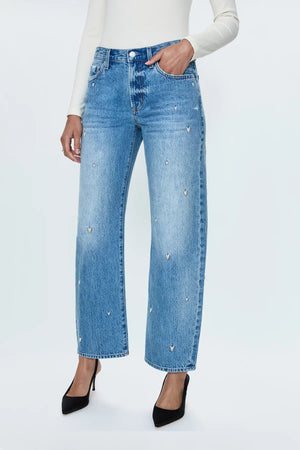 Mid-rise, straight leg with a subtle bow at the thigh and knee for an elevated barrel leg silhouette. Ankle length crop with a clean finish hem, crafted from rigid non-stretch denim for an expert fit that holds its shape. Confetti Vintage is a medium blue wash adorned with an embroidered heart motif throughout and minor hints of distressing.