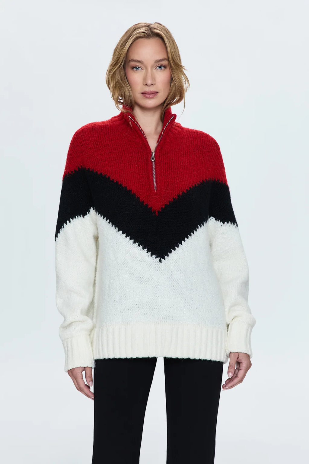 Medium weight pullover sweater with a relaxed pullover fit. With a quarter zip neckline and high sport collar. Lofty ribbing at cuffs and hem. Offered in a multi-colored red and black chevron motif over a cream white base hue.