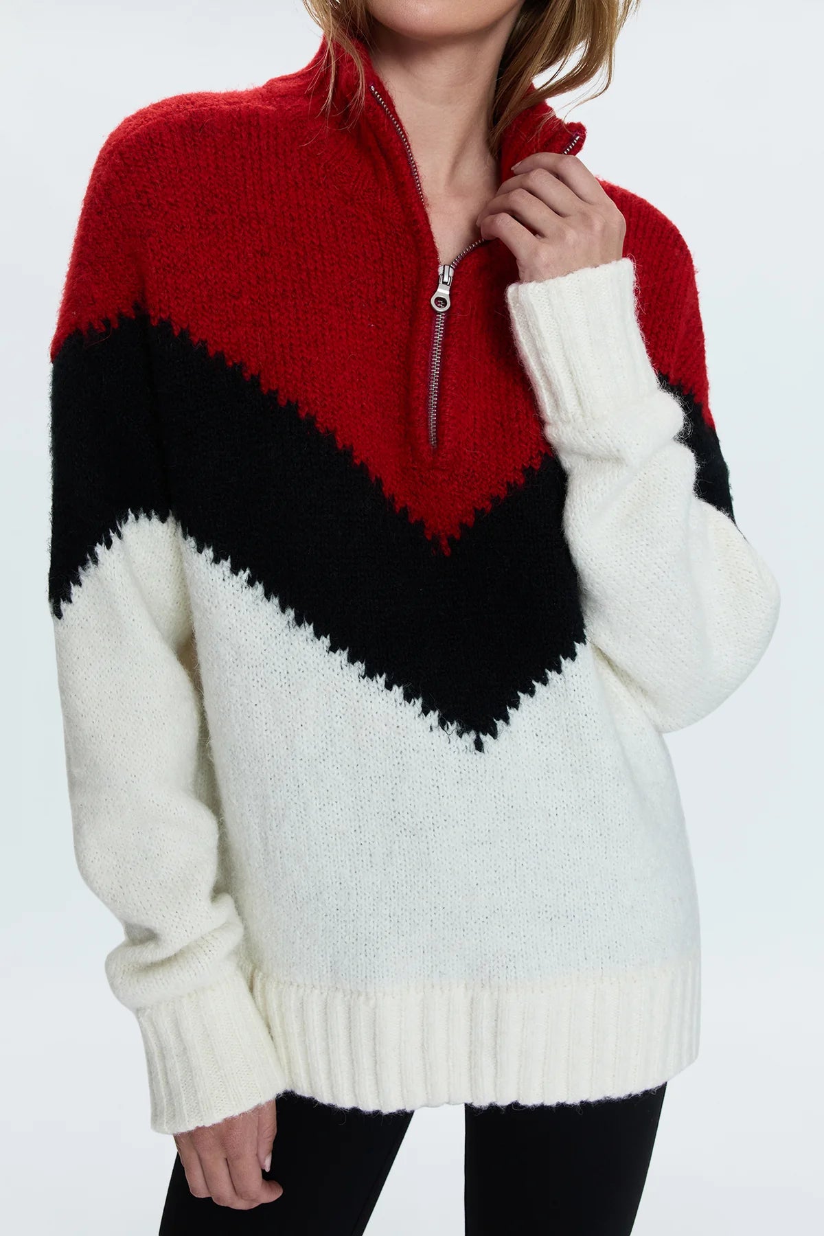 Medium weight pullover sweater with a relaxed pullover fit. With a quarter zip neckline and high sport collar. Lofty ribbing at cuffs and hem. Offered in a multi-colored red and black chevron motif over a cream white base hue.