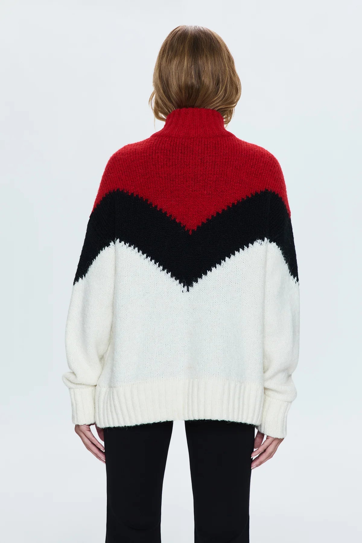 Medium weight pullover sweater with a relaxed pullover fit. With a quarter zip neckline and high sport collar. Lofty ribbing at cuffs and hem. Offered in a multi-colored red and black chevron motif over a cream white base hue.