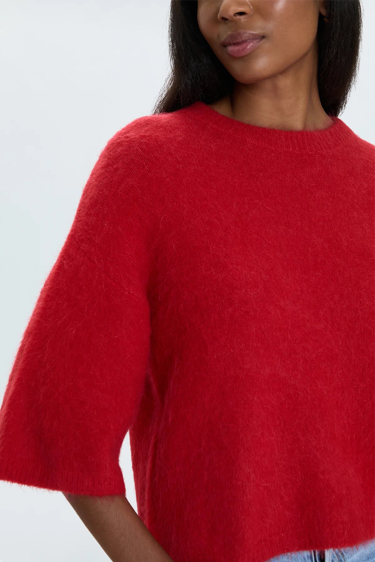 Medium weight wool knit blend with an ultra soft hand feel. Crafted into a relaxed, boxy tee silhouette with a crew neckline, dropped shoulders, and medium length half sleeves. Relaxed ribbing on sleeves, neckline, and hem. Offered in a rich, vibrant red hue.