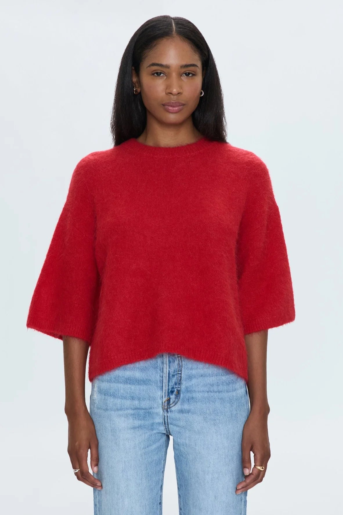 Medium weight wool knit blend with an ultra soft hand feel. Crafted into a relaxed, boxy tee silhouette with a crew neckline, dropped shoulders, and medium length half sleeves. Relaxed ribbing on sleeves, neckline, and hem. Offered in a rich, vibrant red hue.