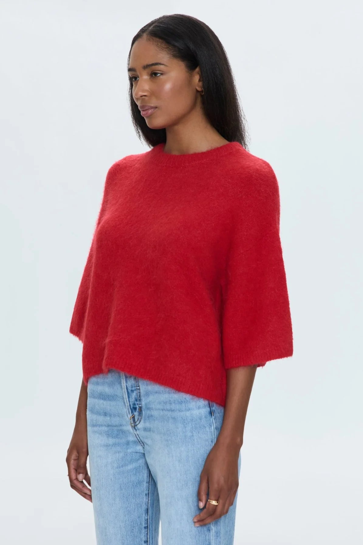 Medium weight wool knit blend with an ultra soft hand feel. Crafted into a relaxed, boxy tee silhouette with a crew neckline, dropped shoulders, and medium length half sleeves. Relaxed ribbing on sleeves, neckline, and hem. Offered in a rich, vibrant red hue.