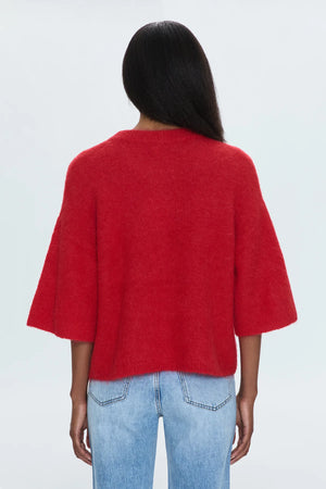 Medium weight wool knit blend with an ultra soft hand feel. Crafted into a relaxed, boxy tee silhouette with a crew neckline, dropped shoulders, and medium length half sleeves. Relaxed ribbing on sleeves, neckline, and hem. Offered in a rich, vibrant red hue.