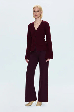 Woman wearing a burgundy suit on a white background