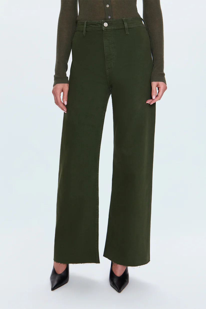 Person wearing green wide-leg pants on a white background