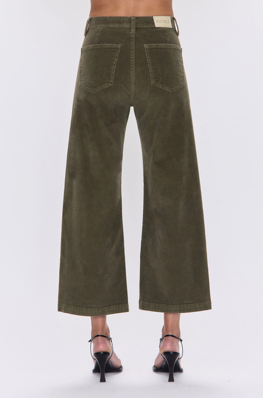 Green wide-leg pants worn by a person on a white background