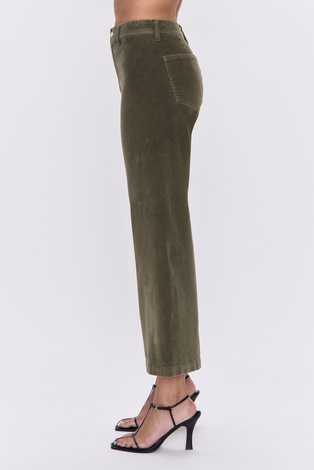 Green pants worn by a person on a white background
