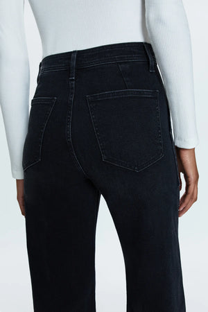 High rise waist, with a wide leg silhouette, front patch pockets and a full length hemline. Crafted from our signature comfort stretch denim, Collins is a washed black denim with utility style patch pockets.