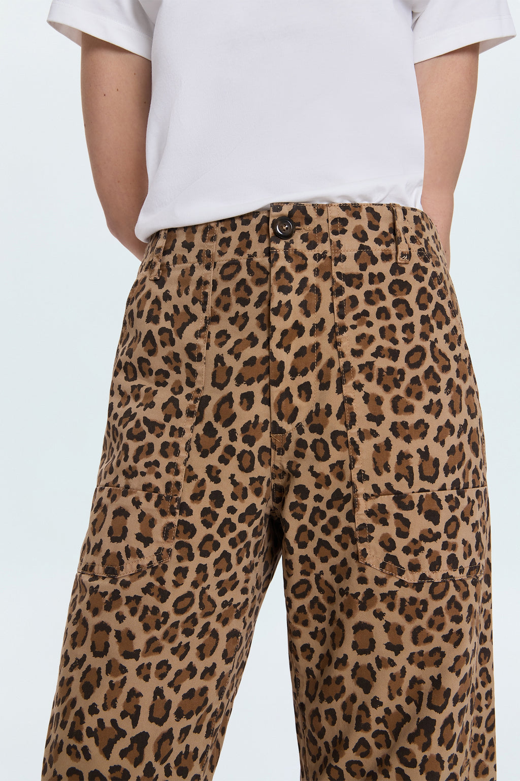 Leopard print pants worn by a person on a white background