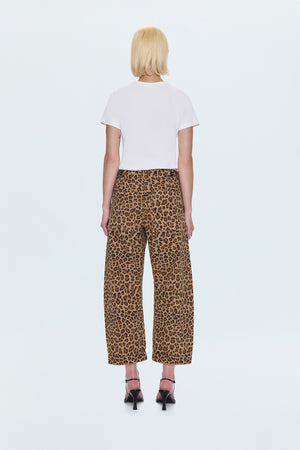 Person wearing a white t-shirt and leopard print pants on a white background