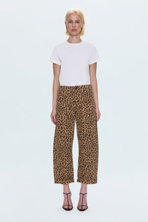 Person wearing a white t-shirt and leopard print pants on a white background