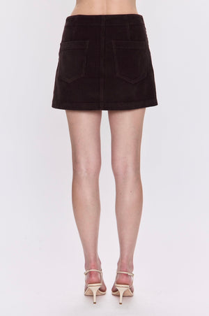 Brown mini skirt worn by a person on a white background