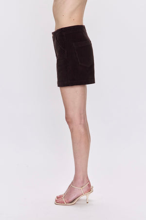 Brown skirt worn by a person on a white background