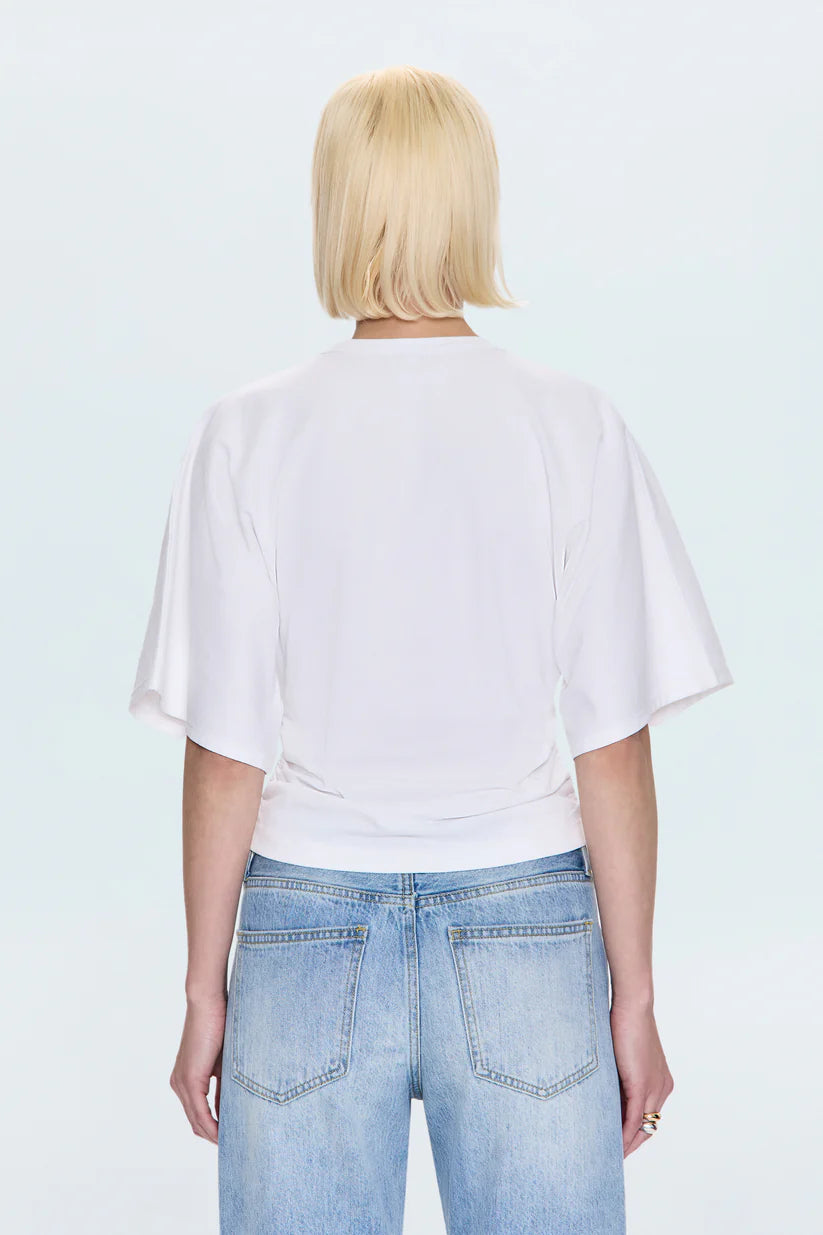 Person wearing a white t-shirt and light blue jeans on a white background