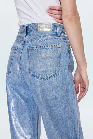 Light blue jeans with a brand label on a white background
