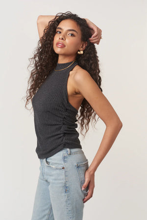 The After The Rain Rib Halter Top features a structured mock neckline and ties that fasten at the neck. Side ruching adds subtle shape through the body, creating a flattering fit with just the right amount of texture. An easy, minimalist staple with a slightly sporty edge.