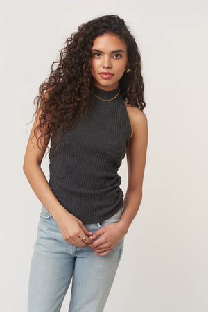 The After The Rain Rib Halter Top features a structured mock neckline and ties that fasten at the neck. Side ruching adds subtle shape through the body, creating a flattering fit with just the right amount of texture. An easy, minimalist staple with a slightly sporty edge.