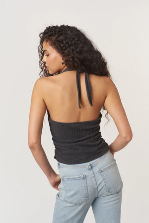 The After The Rain Rib Halter Top features a structured mock neckline and ties that fasten at the neck. Side ruching adds subtle shape through the body, creating a flattering fit with just the right amount of texture. An easy, minimalist staple with a slightly sporty edge.