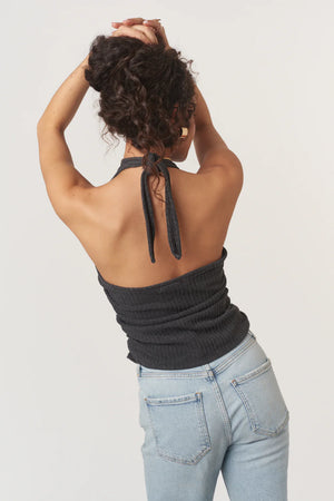 The After The Rain Rib Halter Top features a structured mock neckline and ties that fasten at the neck. Side ruching adds subtle shape through the body, creating a flattering fit with just the right amount of texture. An easy, minimalist staple with a slightly sporty edge.