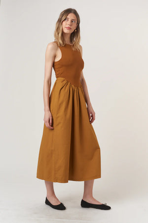 The Corinne Mixed Fabric Tank Dress combines some of our favorite, feminine trends this season. The volume skirt is accentuated at the waist and hits at your ankle, while the top portion is fitted with a scoop neckline and comfortable rib fabric. Of course, we had to add one last fun pop, and you're sure to love the twist detail in the back. Ready to strut off into the sunset with Corinne?