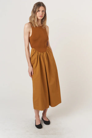 The Corinne Mixed Fabric Tank Dress combines some of our favorite, feminine trends this season. The volume skirt is accentuated at the waist and hits at your ankle, while the top portion is fitted with a scoop neckline and comfortable rib fabric. Of course, we had to add one last fun pop, and you're sure to love the twist detail in the back. Ready to strut off into the sunset with Corinne?