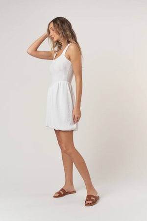 Femme Fatale Rib Bubble Dress is defined by its structured square neckline and voluminous bubble skirt that moves with ease. Fitted through the waist to create shape, this mini dress balances softness and drama in one standout silhouette.