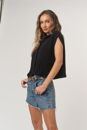 Fernanda Button Front Textured Rib Tee has a relaxed, boxy fit with a soft sweater rib texture. Designed with a pointed collar, roomy pockets, and functional buttons to style solo or layered, it blends structure and ease in a laid-back silhouette.