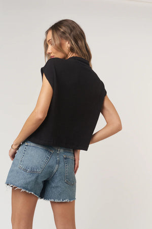 Fernanda Button Front Textured Rib Tee has a relaxed, boxy fit with a soft sweater rib texture. Designed with a pointed collar, roomy pockets, and functional buttons to style solo or layered, it blends structure and ease in a laid-back silhouette.