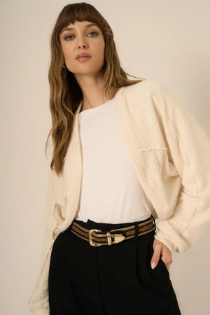 The First Dibs Chenille Cardi is all about keeping it cozy without sacrificing style. Made from a super soft chenille sweater fabric, this relaxed-fit cardi features drop shoulders and a cropped silhouette that elevates any outfit. It’s the perfect piece to throw on over your favorite tops or dresses, so get ready to make layering your new love language.