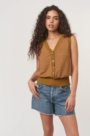 Ingrid Button Front Textured Tank is made from a striped sweater rib with a detailed structure. Designed with a V neckline, front buttons, and a banded hemline for a more tailored fit, it’s an elevated take on a closet essential.