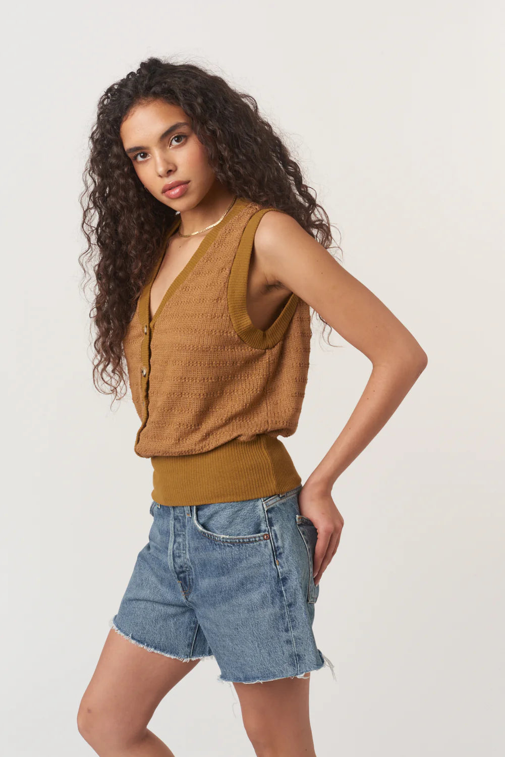 Ingrid Button Front Textured Tank is made from a striped sweater rib with a detailed structure. Designed with a V neckline, front buttons, and a banded hemline for a more tailored fit, it’s an elevated take on a closet essential.