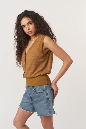 Ingrid Button Front Textured Tank is made from a striped sweater rib with a detailed structure. Designed with a V neckline, front buttons, and a banded hemline for a more tailored fit, it’s an elevated take on a closet essential.