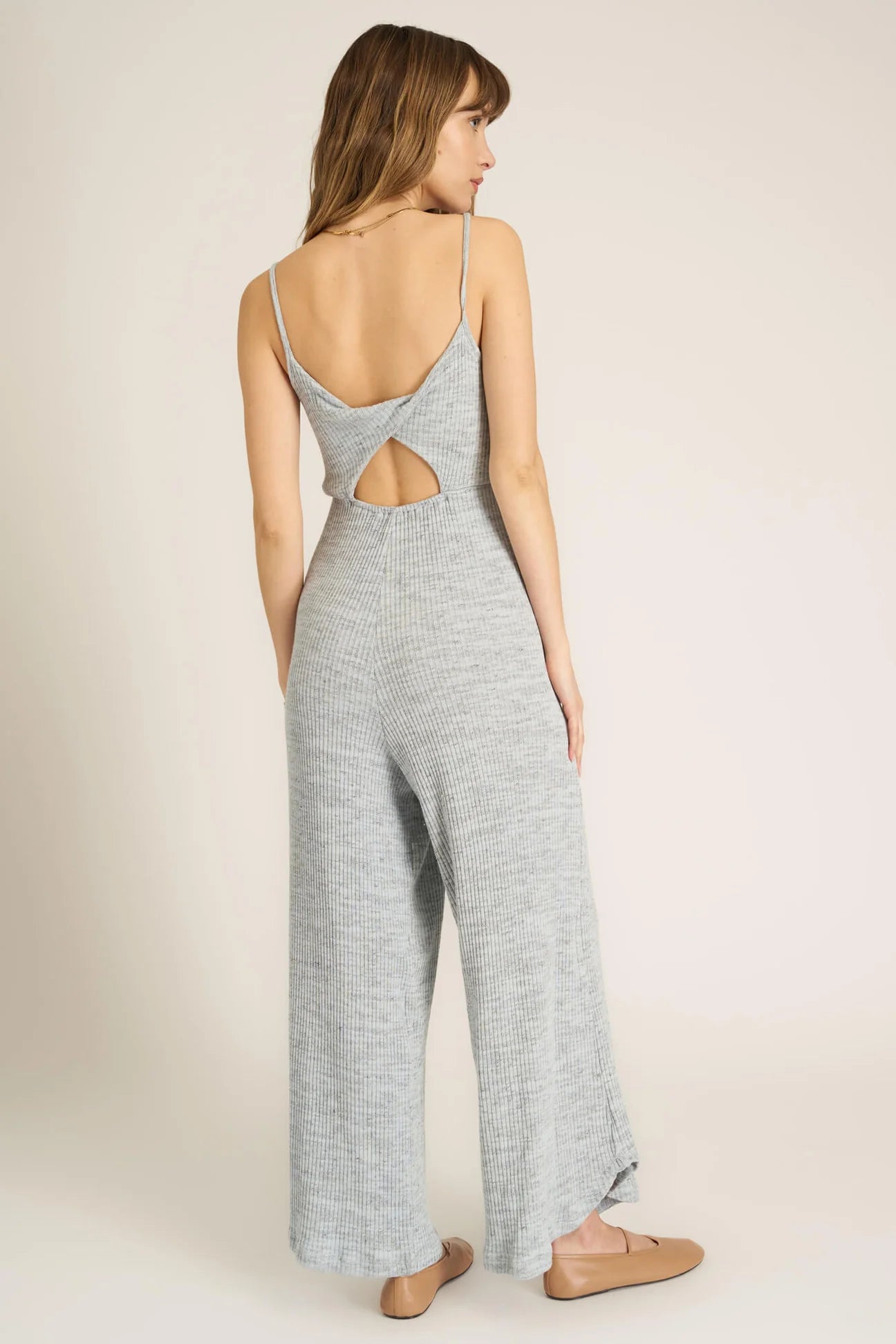 A jumpsuit this good makes us want to dance.  Our Last Dance Twist Back Sweater Rib Jumpsuit is sure to be a best seller. It features a scoop neckline, spaghetti straps, twist-back detail, and a flattering silhouette thanks to the elastic waist. Our sweater rib fabric is a fan favorite, and this time, it gets an all new marled look. Pair with sneakers for a look you'll feel comfortable in all day long.