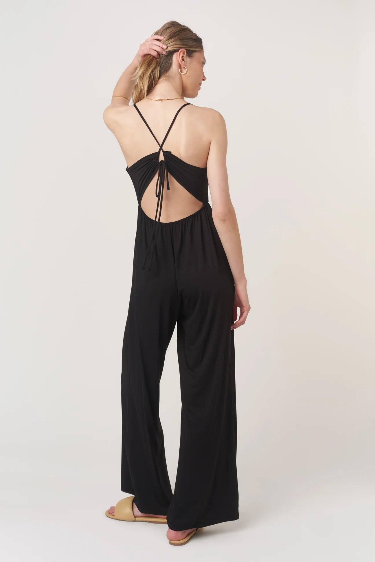 The Night Moves Tie Back Jumpsuit brings effortless chic to any occasion. With a relaxed, flattering fit and a bold strappy back detail, this jumpsuit seamlessly transitions from daytime ease to evening elegance.