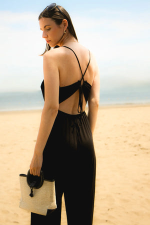 The Night Moves Tie Back Jumpsuit brings effortless chic to any occasion. With a relaxed, flattering fit and a bold strappy back detail, this jumpsuit seamlessly transitions from daytime ease to evening elegance.