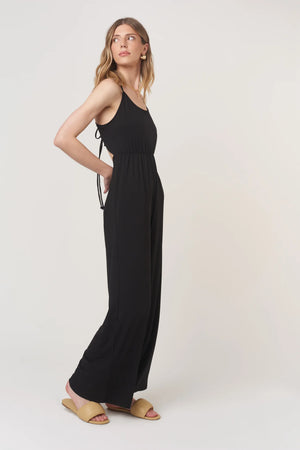 The Night Moves Tie Back Jumpsuit brings effortless chic to any occasion. With a relaxed, flattering fit and a bold strappy back detail, this jumpsuit seamlessly transitions from daytime ease to evening elegance.