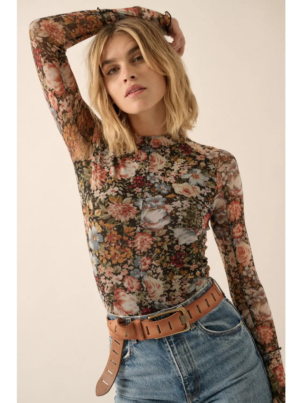 This Promesa top is a stylish pick with a unique twist! With a sultry floral print, semi-sheer mesh fabric, and ruffled cuffs with handy thumbholes, you'll look gorgeous and feel comfy all day. Show off your shape with the fitted silhouette and look effortlessly chic!