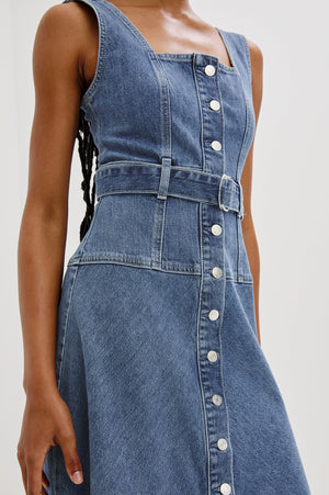 The Aliso denim midi dress features a flared skirt with plenty of movement, crafted from recycled cotton. An adjustable denim belt allows for a personalized, form-flattering fit.