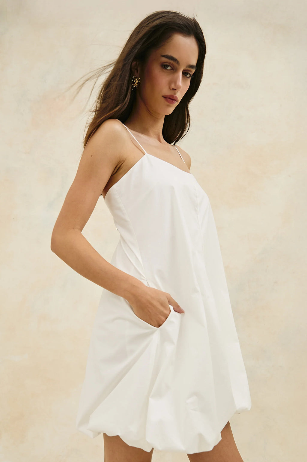 The Blanca is a bubble-hemmed mini dress with big personality. Crafted in crisp cotton poplin—fully lined—with subtle stretch and adjustable straps.