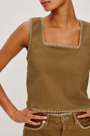 The Carbon is a cropped denim top made from ultra-soft cotton. Featuring a boxy fit, blanket-stitched details, and a hint of stretch, it offers a comfortable, relaxed feel.