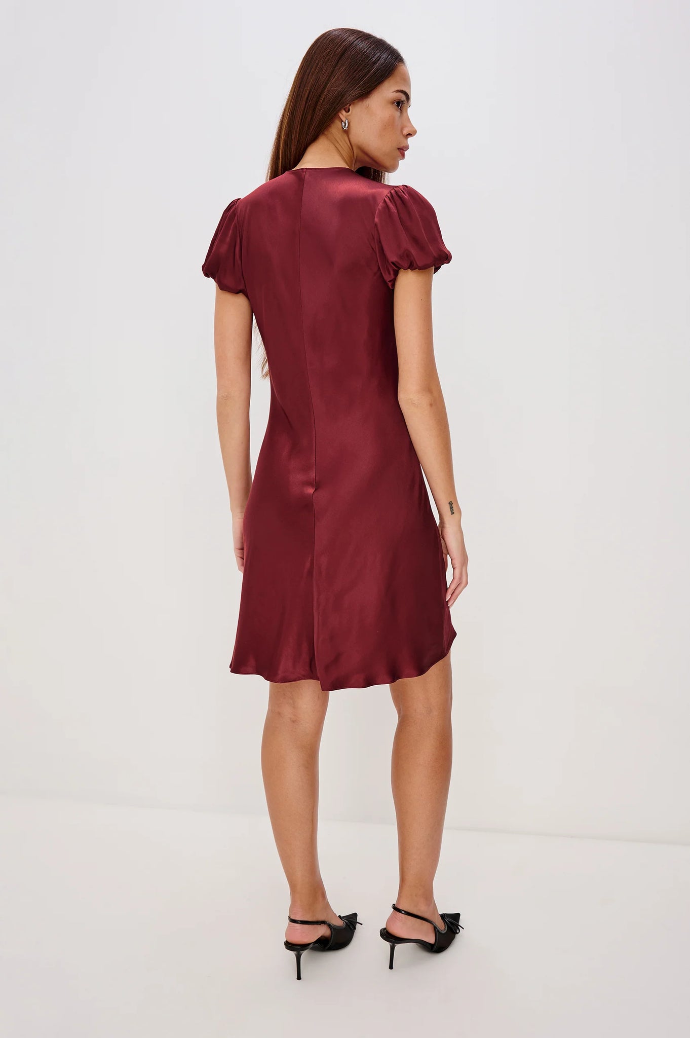 Woman wearing a burgundy dress on a white background