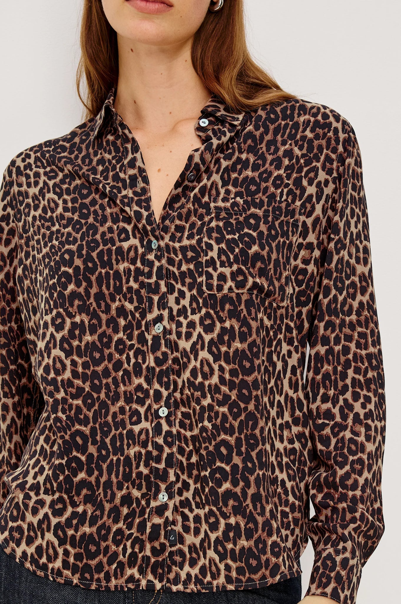 Leopard print shirt worn by a person on a white background