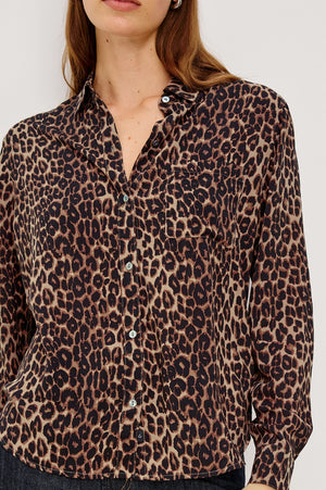 Leopard print shirt worn by a person on a white background